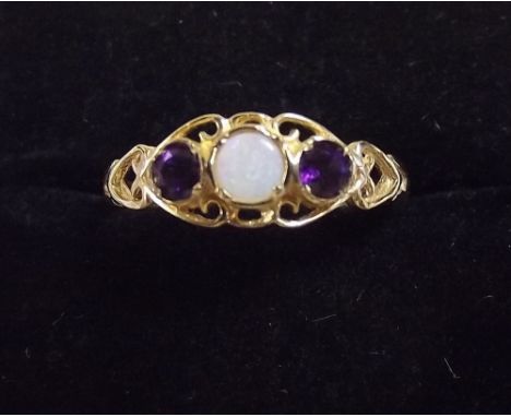 A 9 carat gold amethyst and opal ring