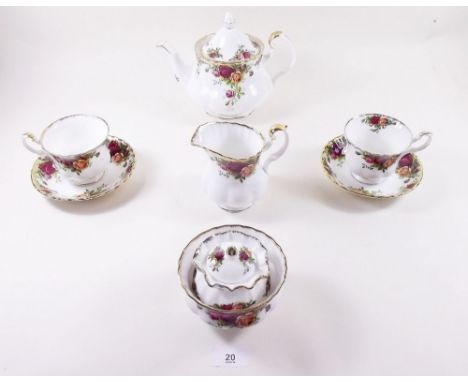 A Royal Albert 'Country Roses' tea service comprising: nine cups, seven saucers, eighteen tea plates, teapot, milk, sugar and