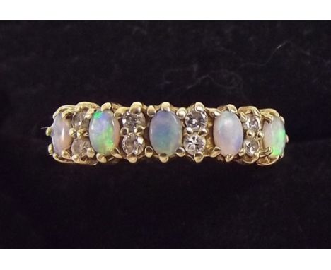 A 9 carat gold opal and diamond set ring