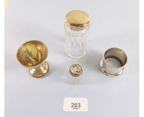 A glass and silver miniature cruet, a similar toiletry jar, a silver egg cup and napkin ring 