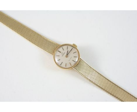 A LADY'S 9CT. GOLD WRISTWATCH BY OMEGA DE VILLE the signed circular dial with baton numerals, on an integrated bracelet, 28 g