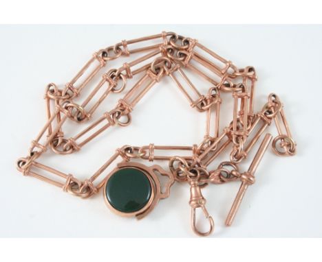 A 9CT. ROSE GOLD WATCH CHAIN suspending a 9ct. gold spinning fob set with a bloodstone and carnelian, 54cm. long, 39 grams.