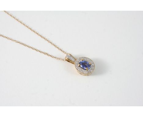 A SAPPHIRE AND DIAMOND CLUSTER PENDANT the oval-shaped sapphire is set within a surround of circular-cut diamonds, with furth