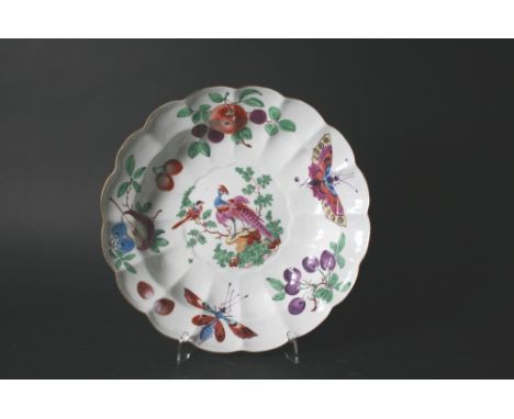 18THC WORCESTER DISH with a shaped rim and boldly painted with a central panel of exotic fancy birds and insects amongst foli