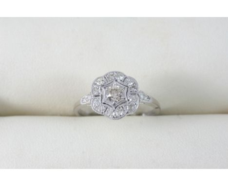 A DIAMOND CLUSTER RING set with circular-cut diamonds, in 18ct. white gold. Size M 1/2.