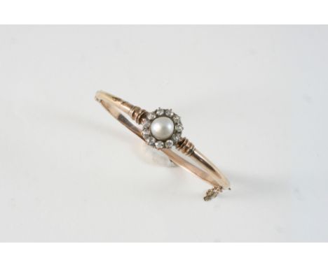 A GOLD, DIAMOND AND PEARL HALF HINGED BANGLE the gold bangle is centred with an untested pearl within a surround of old brill