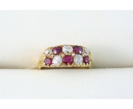 A RUBY AND DIAMOND TWO ROW RING set with alternate circular-cut rubies and cushion-shaped diamonds, in gold. Size K 1/2.