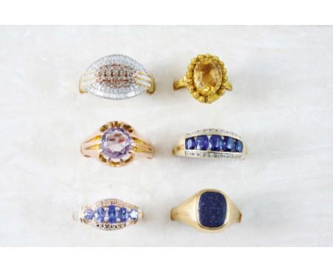 AN AMETHYST SINGLE STONE RING set in 9ct. gold, size R 1/2, a citrine single stone ring, size L, and four other gold and gem 