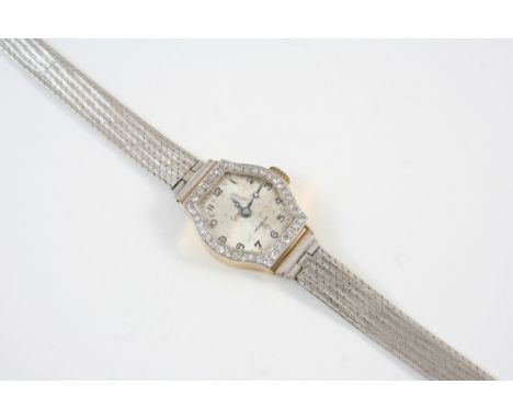 A LADY'S DIAMOND AND GOLD COCKTAIL WRISTWATCH the dial with Arabic numerals and with single-cut diamonds set to the bezel, on
