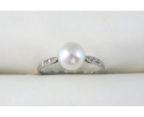 A NATURAL PEARL AND DIAMOND RING set with six small shoulder diamonds. Size Q. Accompanied by report number 11306 from The Ge