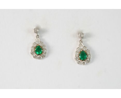 A PAIR OF EMERALD AND DIAMOND DROP EARRINGS each set with a pear-shaped emerald within a surround of circular-cut diamonds, s