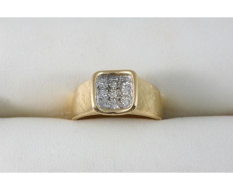 A DIAMOND RING BY GRAFF set with a panel of nine circular-cut diamonds, in 18ct. gold, signed Graff to the inner shank. Size 