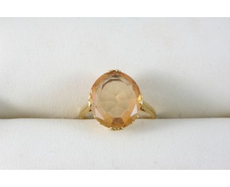 A TOPAZ SINGLE STONE RING set with an oval-shaped topaz in gold. Size I.