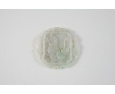 A CIRCULAR CARVED JADE PENDANT carved with foliate decoration, 5cm. dia.