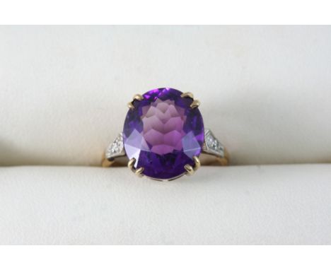 AN AMETHYST AND DIAMOND RING the oval-shaped amethyst is set with two small diamonds to each shoulder, in gold and platinum. 