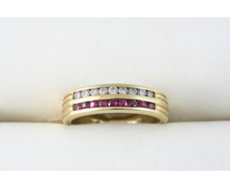 A RUBY AND DIAMOND TWO ROW RING set with graduated circular-cut rubies and diamonds, in 18ct. gold. Size O.