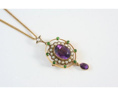 AN EARLY 20TH CENTURY AMETHYST, PEARL AND GARNET PENDANT the oval-shaped amethyst is set within a surround of small pearls an