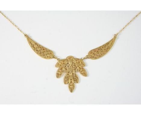 AN 18CT. GOLD FILIGREE NECKLACE formed as three open work sections, on a fine link gold chain, 38.5cm. long, 17 grams.