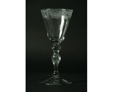 A NEWCASTLE LIGHT BALUSTER GOBLET lambrequin engraved, rounded funnel bowl on conical foot 8" (19.5 cm) high