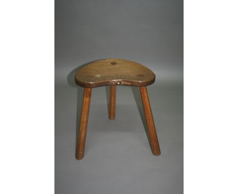 'MOUSEMAN' ROBERT THOMPSON OF KILBURN - STOOL a carved stool supported on three tapering legs, with a curved seat and carved 