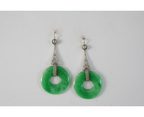 A PAIR OF ART DECO JADE AND DIAMOND DROP EARRINGS each set with a jade disc set with a row of single-cut diamonds, 5cm. long.