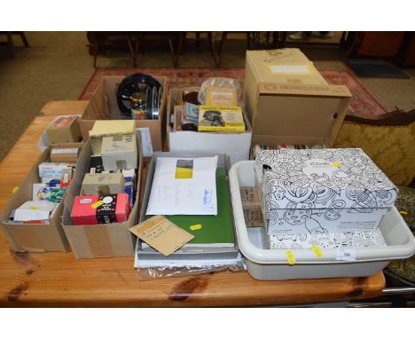 A large collection of projector and film editing accessories, bulbs, reels and other items