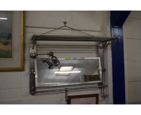 A chrome finish combination mirror light and shelf