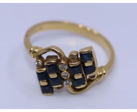 An 18ct yellow gold, diamond and sapphire cross-over ring,&nbsp;set eight square cut sapphires and bezel set seven round cut 