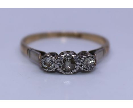 A 9ct. yellow gold and platinum three stone diamond ring,&nbsp; flush set three graduated old-cut diamonds, gross weight 2.1g