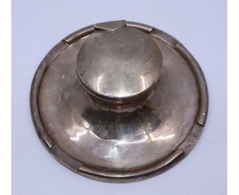 A large silver capstan inkwell