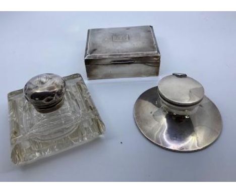 A silver capstan inkwell, silver cigarette box and a silver topped glass inkwell&nbsp;