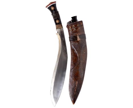 A kukri, heavy hollow ground blade 14.5 in. with decorating fullers to the lower part, hilt with fluted brass ferrule and car