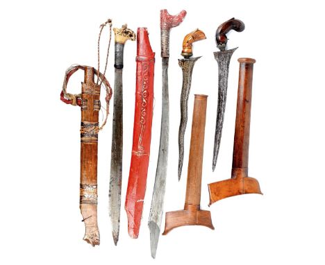 Two Javanese daggers (kris), one with 12.5 in. wavy blade, the other with 12.5 in. sllightly curved blade, each with faceted 