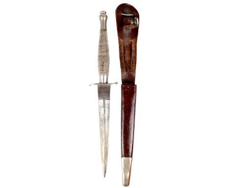 A scarce Fairbairn-Sykes fighting knife, first pattern second type, blade 6.75 in. with etched ricasso, two inch wavy crossgu