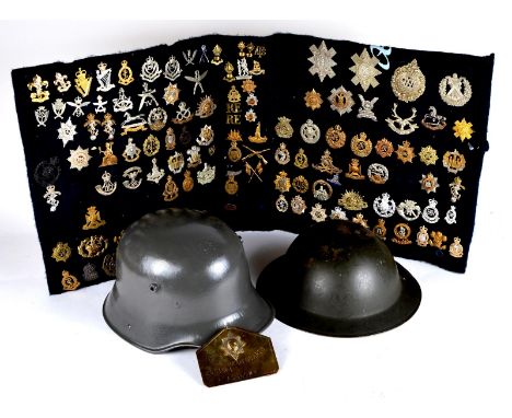 A large collection of cap badges, and other insignia, including a large proportion of restrikes; together with a Brodie helme