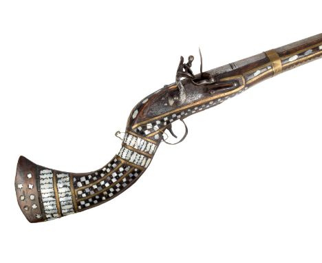 An Afghan flintlock jezail, with a 106cm long barrel with a flared muzzle, with a wooden stock with brass and mother of pearl