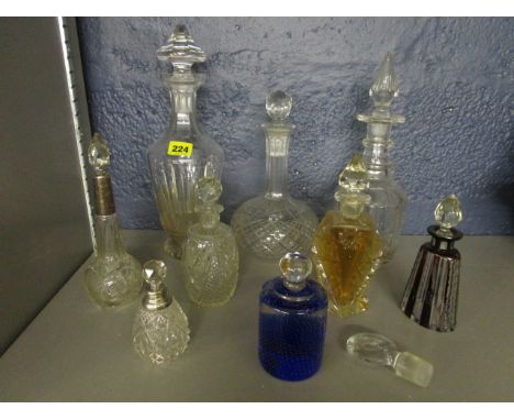 A group of cut glass decanters, dressing table bottles, some with silver collars, a Georgian bulls eye decanter stopper and a