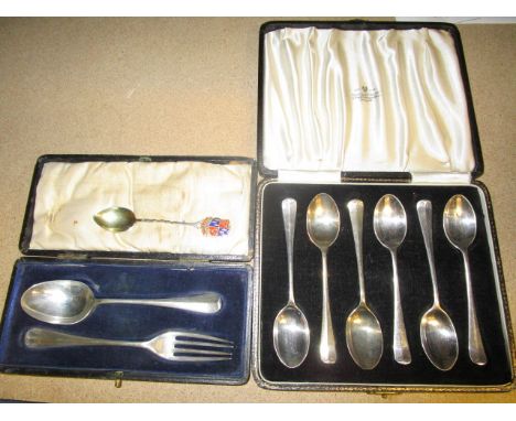 A George VI cased set of six silver, rat tail coffee spoons, Sheffield 1945, a George V cased silver spoon and fork set, Birm