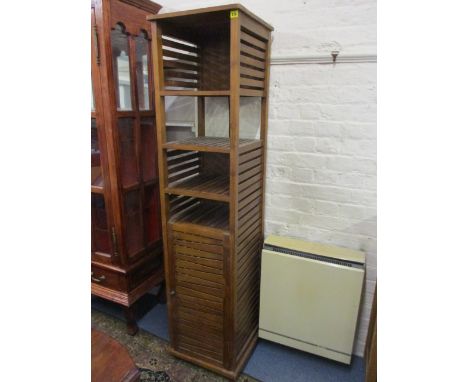 A modern bathroom shelf unit with slatted sides and slatted cupboard door, 70 h x 17 w x 17 d