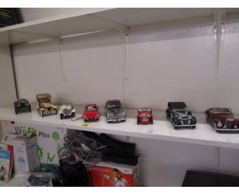 Eight Franklin Mint, diecast model cars to include 1:24 scale model of a Rolls Royce and a 1988 model of an SS Jaguar