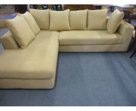 A modern corner sofa in a beige cheesecloth fabric with seven  matching cushions, 103 x 85