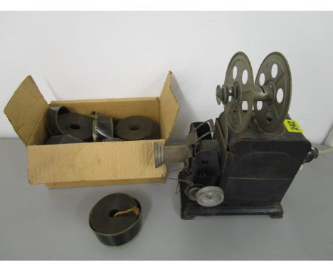 An early 20th century tin plate projector, together with a group of films