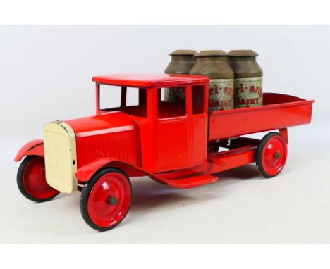 Tri-ang - An unboxed Tri-ang pressed steel long bonnet Bedford Tipping truck with Tri-ang Milk Churn Load. The vintage truck 