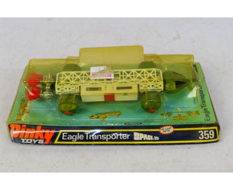 Dinky - A boxed Space 1999 Eagle Transporter #359. Items appears to be in excellent condition. Item comes in a storage worn b