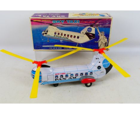 Haji (Japan) - A boxed Haji (Japan) battery operated tinplate Sky Taxi 'Pan Am'. The model appears to be in Excellent conditi