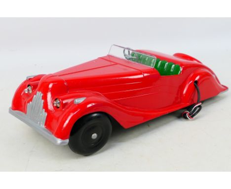 Codeg - A streamlined unboxed red Bakelite Codeg Armstrong Siddeley ‘Modern Motor Car’. The cars appears to have be 'customis
