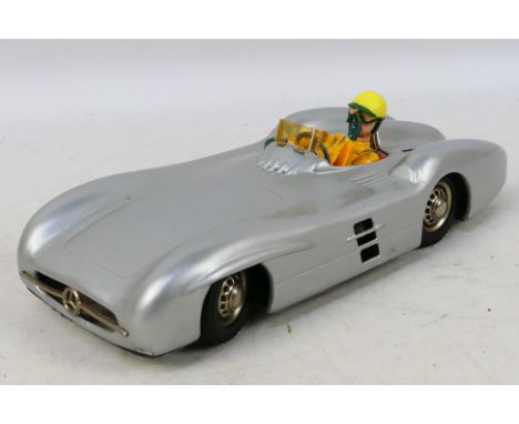 JNF (West Germany) - An unboxed battery powered tinplate Mercedes Silver Arrow Racing Car. The car appears to have been repai