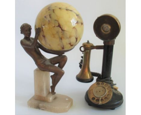 An early 20th century candlestick telephone, together with an Art Deco-style figure, depicting a semi-clad lady on alabaster 