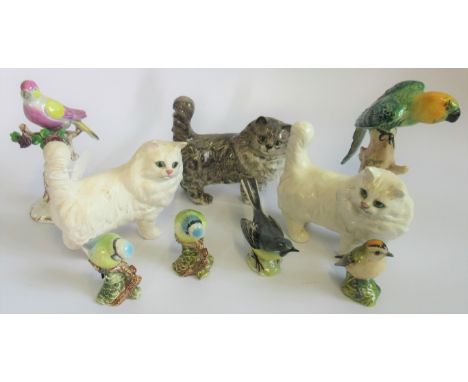 A collection of three Beswick cats, together with four Beswick birds, comprising: pair of Blue Tits, Grey Wagtail and a Goldc