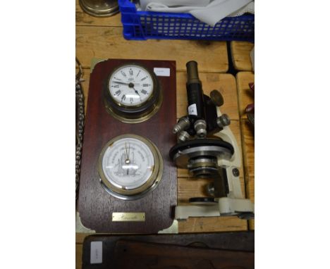 A microscope and a combination barometer/clock.